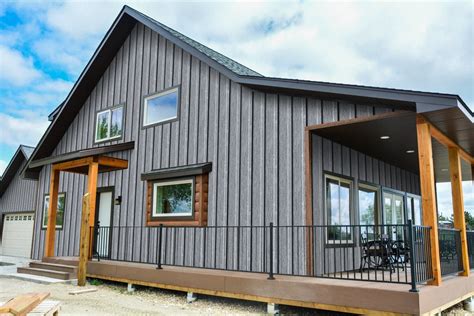 ranch house with gray siding & charcoal metal roofing|ranch style house exterior ideas.